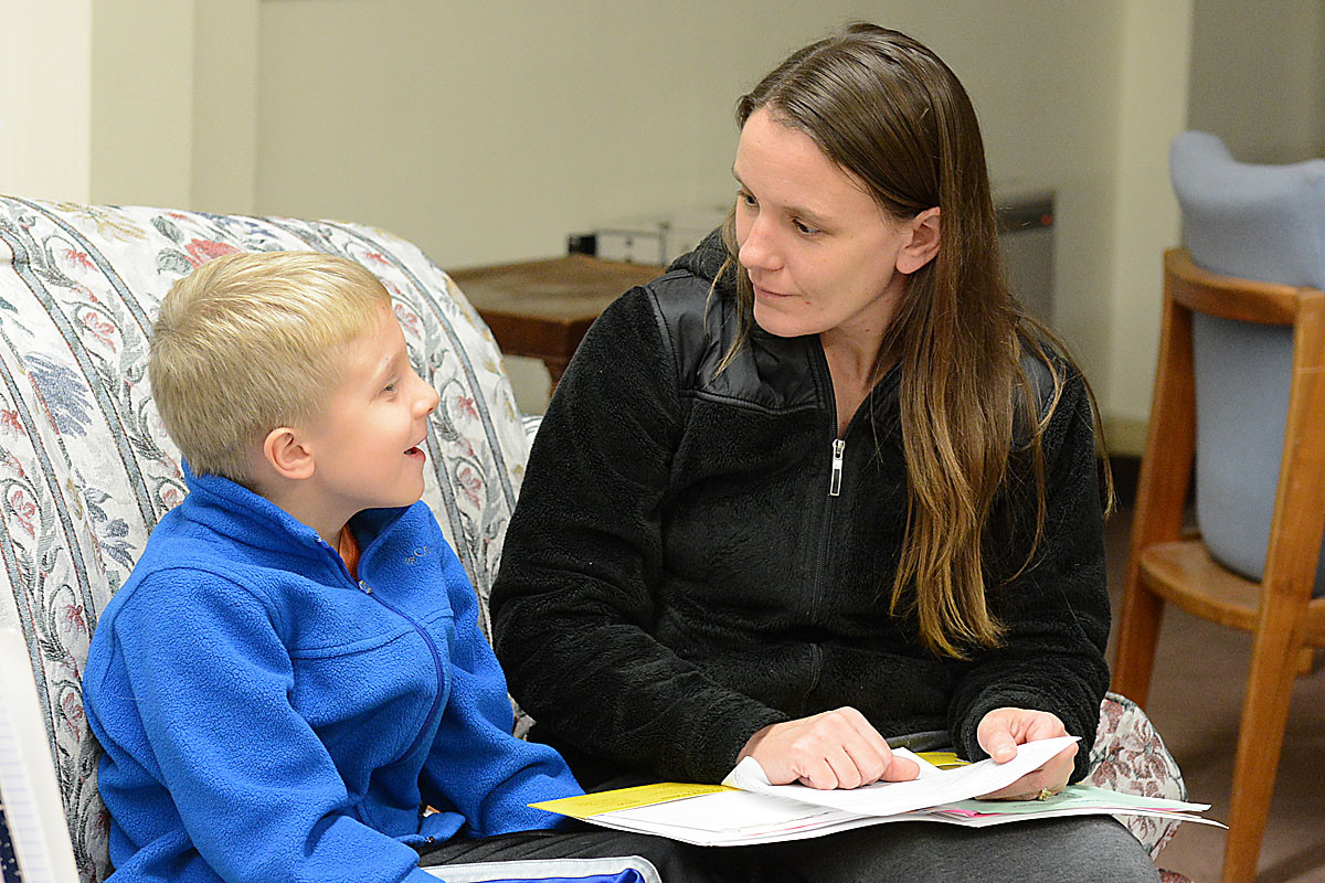 Diana Stanczyk teaches her son Neil, 7, about the sacrament of reconciliation at the St. Clare Center, Tonawanda. (Patrick McPartland/Staff Photographer)