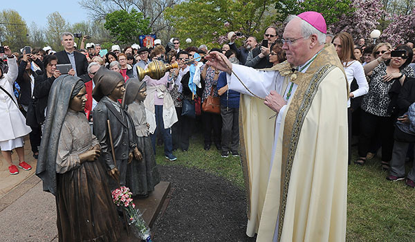 Bishop Malone Blesses a statue of the three Portuguese shepherds in front of the Fatima Shrine in Lewiston to celebrate the 100th anniversary of the Three Secrets of Fatima. Bishop Malone announced to the crowd that two of the sisters where given sainthood hours before the Mass. The Three Secrets of Fátima consist of a series of apocalyptic visions and prophecies which were given to three young Portuguese shepherds, Lúcia Santos and her cousins Jacinta and Francisco Marto, by a Marian apparition, starting on May 13, 1917. The three children were visited by the Virgin Mary six times between May and October 1917. The apparition is now popularly known as Our Lady of Fatima. (Dan Cappellazzo/Staff Photographer)