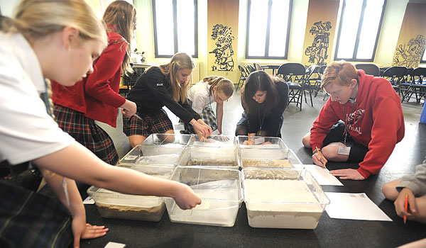 Students work as a team and learn how to conduct an archaeological dig on frozen ground during a breakout session at the Buffalo Museum of Science. After viewing a screening of `Finding Noah,` students worked on different projects related to filmmaking and archaeology. (Patrick McPartland/Staff Photographer)