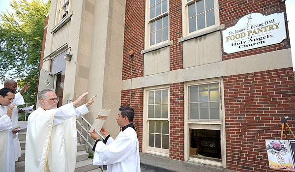 Missionary Oblates of Mary Immaculate Provincial Father Bill Antone, OMI, blesses the Father James C. Erving, OMI, Food Pantry at Holy Angels Church on Sept. 10. (Patrick McPartland/Staff Photographer)