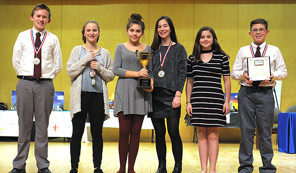 Members of the St. Andrews Country Day School team Jacob Wilkes (from left), Olivia Foglia-Leffler, Vivian Figueroa, Gwen Shivinshky, Mikayla Valentine and Joe Rebhan accept a fifth place finalists award at Mount St. Mary's High School Auditorium during the 2018 Future Cities competition. Western New York's brightest sixth, seventh and eighth graders competed in regional finals, presenting their solutions for an age friendly city. St. Andrews also received an award for most unique engineering design. (Dan Cappellazzo/Staff Photographer)