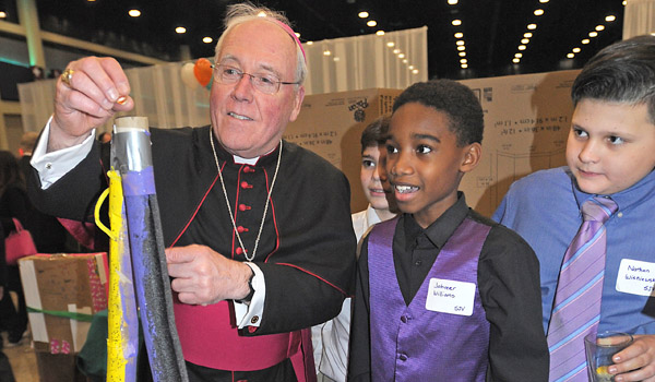 Bishop Richard J. Malone tries `The Huuuuuuh,` a science project entered in the 2016 Stream Competition by St. John Vianney 6th graders Greyson Settipane (from left), Jahveer Williams and Nathan Wisniewski. Area Catholic School students set up their projects at the 2017 Catholic Education GALA 22:6 Thursday evening at the Buffalo Niagara Convention Center. Over 1,000 attendees turned out to support Catholic Education. (Dan Cappellazzo/Staff Photographer)