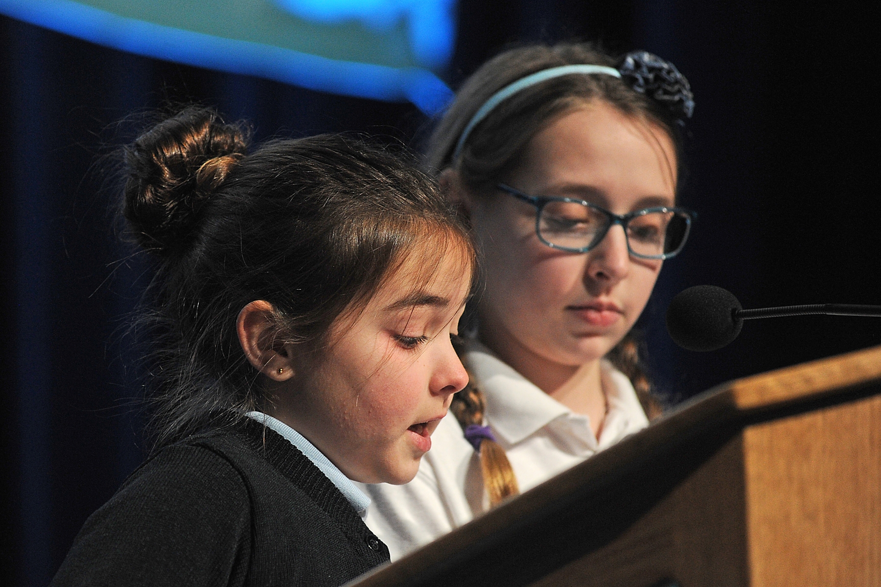 St. John's School, of Kenmore, 4th grader Natalie Cook and her sister, 6th grader, Lily Cook lead the crowd in prayer at the Buffalo Niagara Convention Center to begin the Gala 22:6 `A Celebration of Catholic Education.`