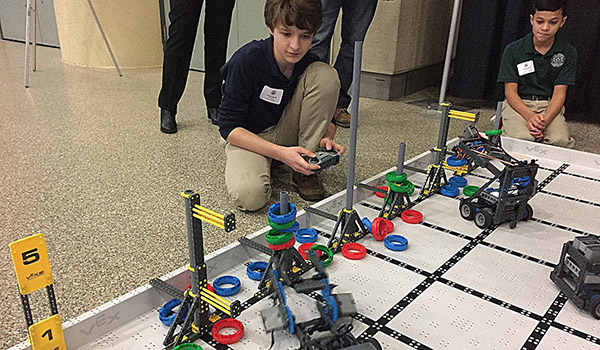 Nardin Academy eighth-grader Connor Rutowski shows off his robotics skills at the Foundation of the Roman Catholic Diocese of Buffalo's largest annual fundraiser, GALA 22:6, held Thursday night at the Buffalo Convention Center. (Patrick McPartland/Managing Editor)