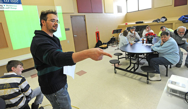 Mario Vinti, diocesan associate director of Lifelong Faith Formation, speaks about the teachings of the Bible to area families at Baker Hall School in Lackawanna. The program offers an opportunity for people of all ages with disabilities to be included in faith formation with their families. (Dan Cappellazzo/Staff Photographer)