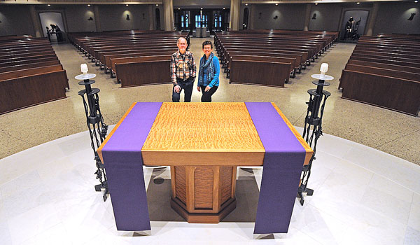 Donna Allan stands with her father, master woodworker Donald Herberger, who built this altar as well as the lecturn and tabernacle stand at St. Mary Parish in Swormville. (Dan Cappellazzo/Staff Photographer)