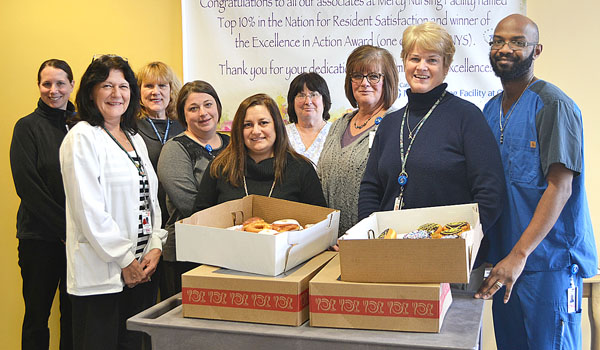 Executive Director Patricia O'Connor (second right), and associates from the Mercy Nursing Facility, prepare to deliver donuts to the staff for a `sweet` celebration recognizing Mercy Nursing at the Our Lady of Victory Senior Neighborhood's rating among the New York State Department of Health's Top Performing Nursing Homes.