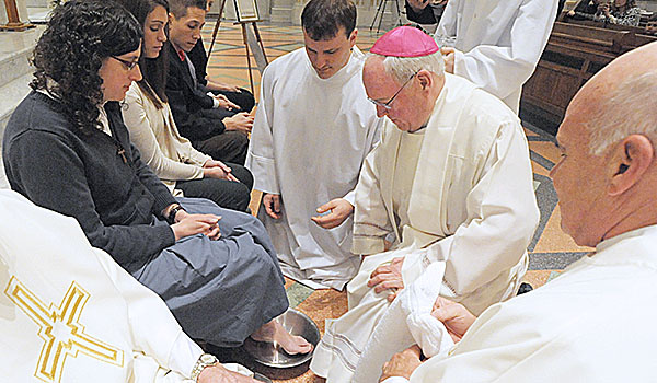 For the first time Bishop Richard J. Malone washes the feet of women during Evening Mass of the Lord's Supper, Holy Thursday, celebration at St. Joseph Cathedral. (Patrick McPartland/Staff Photographer)