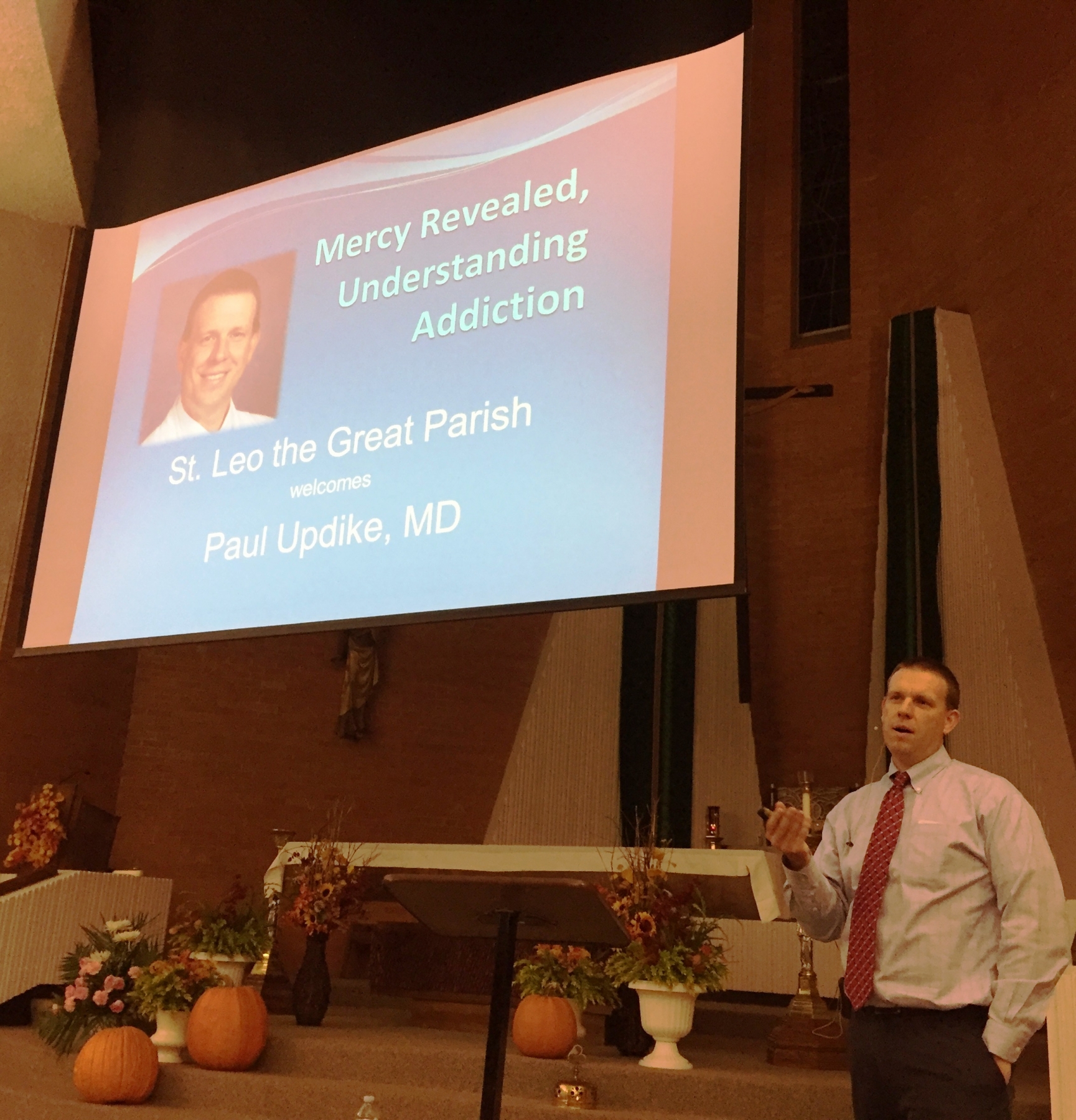 Dr. Paul Updike, director of Addiction Medicine and Recovery Services for Catholic Health System, speaks to a crowd at St. Leo the Great Church on November 15, 2016.
