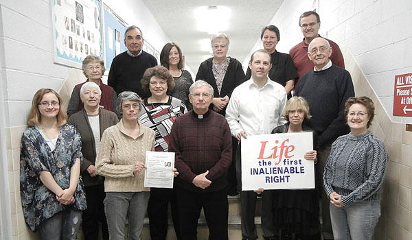 Father Dennis Fronczak, pastor of Our Lady of Pompeii Parish, stands with the Respect Life committee. (Courtesy of Our Lady of Pompeii Parish)