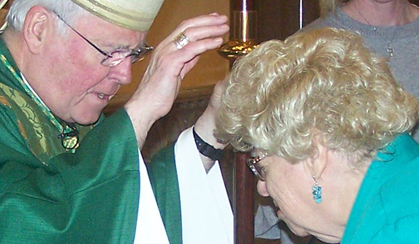 Bishop Richard J. Malone blesses Sandra Tapaspo, the new Respect Life Coordinator from Blessed Mary Angela Parish in Dunkirk, during the annual Respect Life and Commissioning Mass sponsored by the office of Pro-Life Activities. The Oct. 6 Mass took place at St. Louis Parish in downtown Buffalo. (Patrick J. Buechi/WNY Staff)