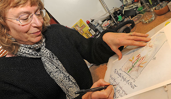 Joan Dorbin of Amherst strives to put the perfect handwritten touch on every piece she creates. (Dan Cappellazzo/Staff Photographer)