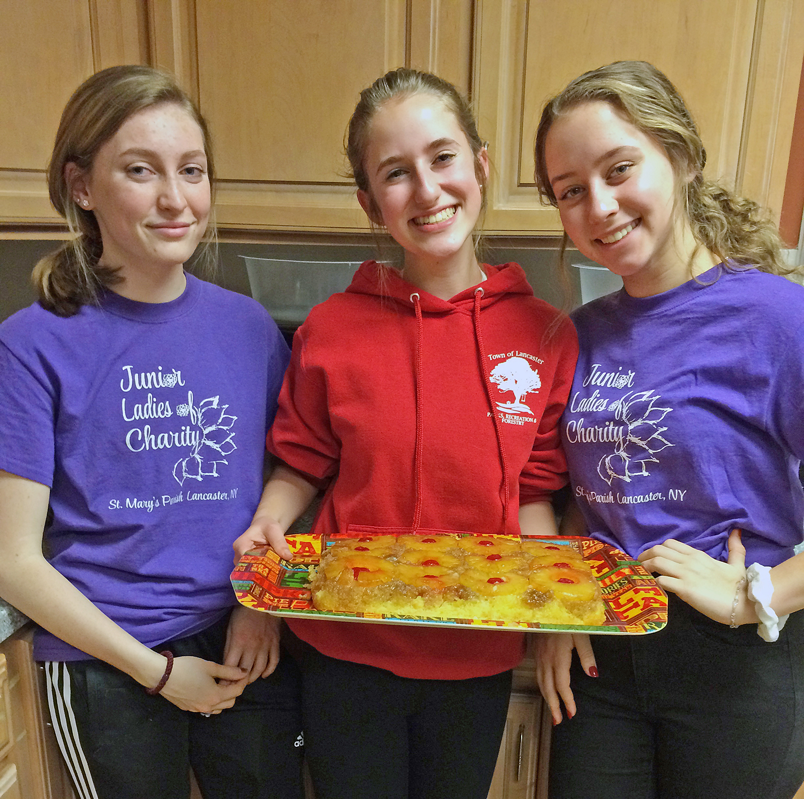 With their tray of homemade pineapple upside down cake are Lauren Richardson, Olivia Dobiesz, and Kristina Kwitzer volunteer at Ronald McDonald House. (Patrick McPartland/Managing Editor)