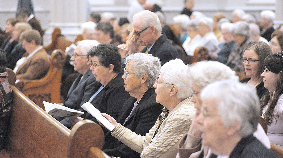 Women and men who are celebrating their silver, gold and diamond jubilees pray at St. Joseph Cathedral during the Jubilee Mass. (Dan Cappellazzo/Staff Photographer)
