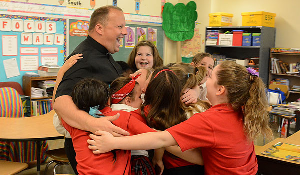 Rev. Mr. Lukasz Kopala stops into say goodbye to Mary Beth Smith's fourth-grade class at Catholic Academy of Niagara Falls.
(Patrick McPartland/Staff Photographer)