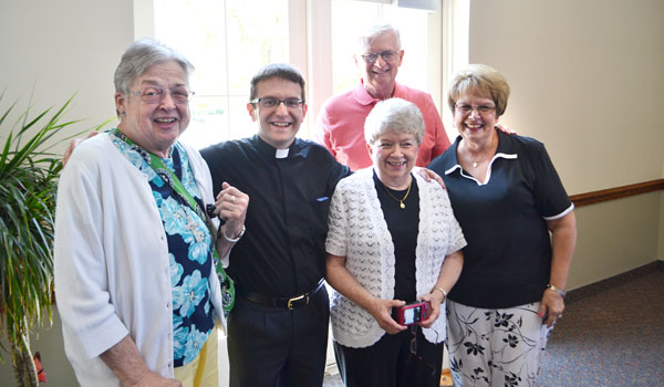 Father David Krzeszowski with some of his parishioners at St. John the Baptist in Kenmore.