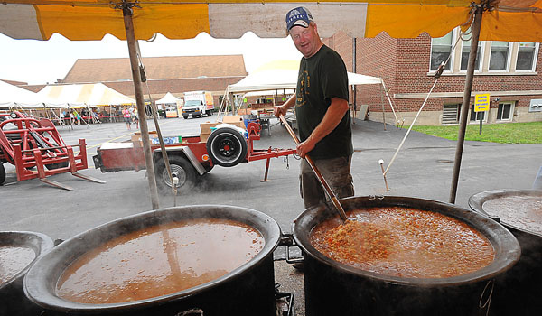 Parishioner Patrick Spoth stirs up some chowder at the St. Mary Swornville Lawn Fete. The parish has held the picnic since 1845. 
(Patrick McPartland/Staff Photographer)
