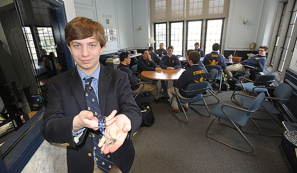 Canisius High School junior James Lyon stands in class while holding the one-decade rosary that he made. (Dan Cappellazzo/Staff Photographer)