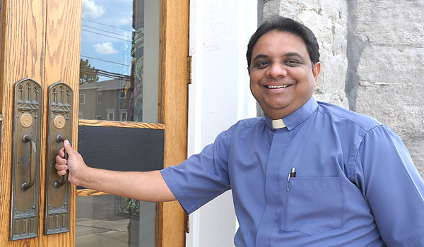 Father Johnson Machado has come to enjoy American food. He is still working on his English and the American accent.
(Patrick McPartland/Staff Photographer)