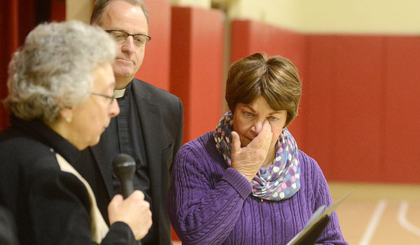 St. Peter School Kindergarten teacher Linda Calandrelli (right) wipes away tears as Superintendent of Catholic Schools Sister Carol Cimino (left), SSJ, announces that Caladelli has been awarded the Sister Lucille Socciarelli-Father John Sturm: Making a Difference Award. (Patrick McPartland/Staff Photographer)