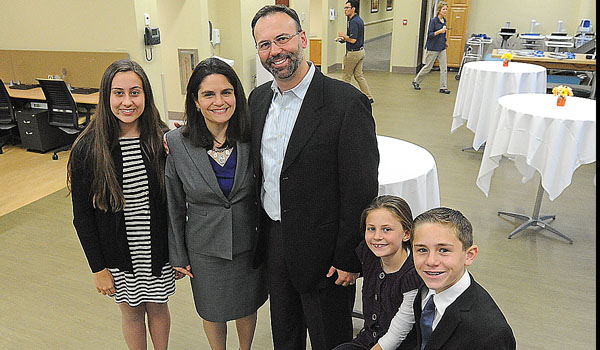 Surrounded by his family (daughter Paityn, wife Deanne, daughter Eva, and son Shane Daley), Mark Messenger, who fell from a tree this summer, regained his ability to walk with the help of the staff from Catholic Health's McAuley Residence. (Dan Cappellazzo/Staff Photographer)
