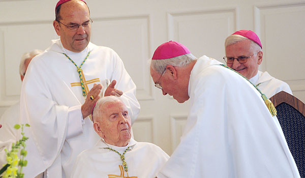 Bishop Robert J. Cunningham, bishop of Syracuse stands behind Bishop Bernard J. McLaughlin, auxiliary bishop emeritus of the Diocese of Buffalo, at the beginning of Bishop McLaughlin's 100th birthday Mass, celebrated at St. John the Baptist Church, Kenmore in 2012. (Patrick McPartland/Staff Photographer)