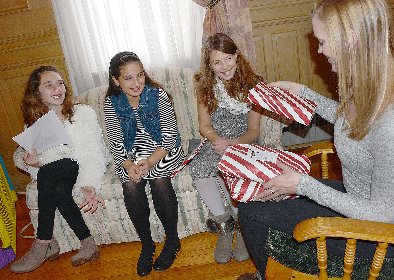 Nativity of Our Lord School Orchard Park sixth graders Amelia Lazzara, Ella Ignatius and Leah Banes present Mother Teresa House coordinator Olivia Giza with gifts  they bought with money they raised through a newspaper they created as fifth graders. Lazzara, who spearheaded the project, said she and her fellow students wanted to donate toys to need children of the holiday. The Mother Teresa house, which is located at 208 Stanislaus Street, on Buffalo's East Side, provides shelter, community service, and education referral services for mothers in need. The gifts will be give to needy children during a Christmas at the Mother Teresa House. (Dan Cappellazzo/Staff Photographer)