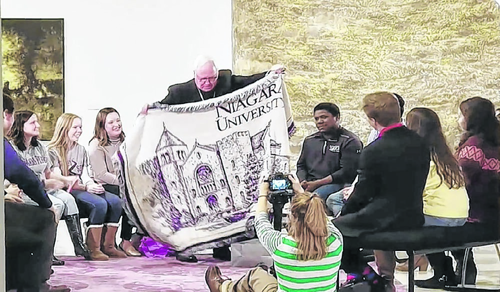 Bishop Richard J. Malone receives a gift from the Niagara University students after a recording of `Campus Chat.` (Courtesy of Daybreak TV)