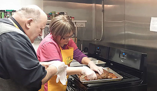 On this month's episode of `Our Daily Bread,` host Father Paul Seil prepares food with Marsha, one of the cooks at Little Portion Friary in Buffalo.