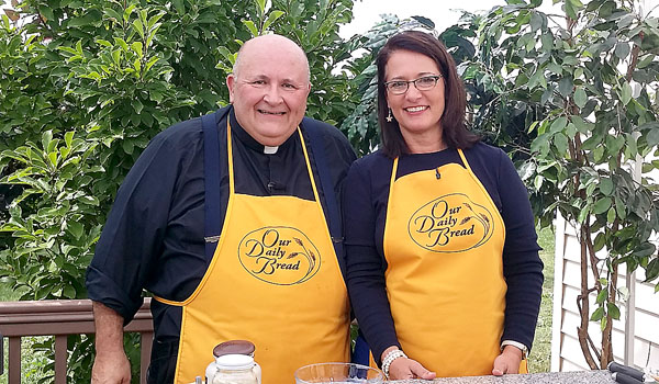 Father Paul D. Seil, host of `Our Daily Bread,` cooks with Nancy Scherr, director of the Office of Family Life Ministries for the Diocese of Buffalo. (Courtesy of Daybreak TV Productions)