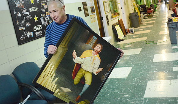  O'Hara High School's Father Tom Ribits, OSFS, rescues art work from the school Chapel after a weekend flood caused heavy damage in the Senior Hallway wing of theTown of Tonawanda School.The Senior Hallway will be walled off indefinitely as crews begin rebuilding that area of the school.
(Dan Cappellazzo/Staff photographer)