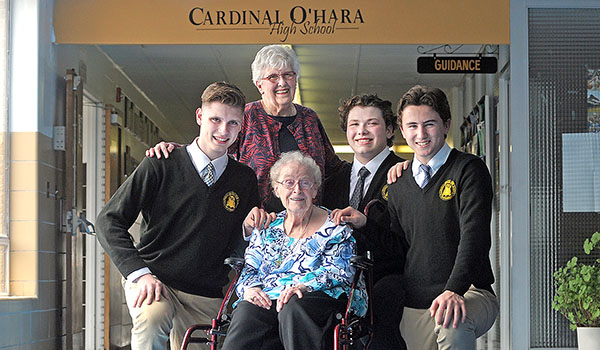 Sister Rita Kane thanks Cardinal O'Hara High School's Brandon Heacock, Ethan Wrona and Jason Wrona in the main hall of the school. The students aided Sister Rita and Donna Juenker who were both stranded at the O'Hara Residence during a rainy day last April. (Dan Cappellazzo/Staff Photographer)