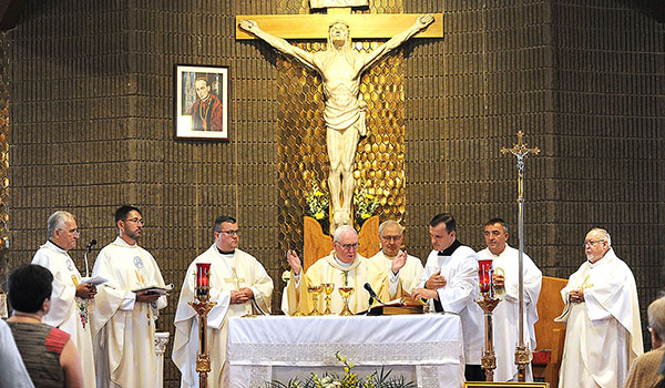 Bishop Richard J. Malone prays over the gifts at Our Lady of Bistrica Church, Lackawanna, on the parish's 100th anniversary, during a centennial Mass at the Abbott Road Church. (Dan Cappellazzo/Staff Photographer)