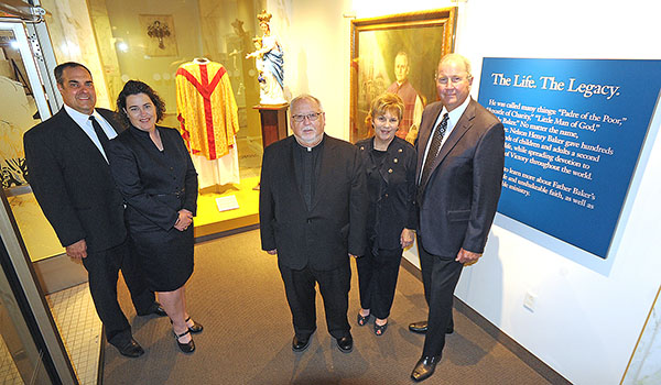 John (from left) and Betsy Sullivan, Msgr. Paul J. E. Burkard, and Karen and Dick Penfold, stand in the Father Baker Museum at Our Lady of Victory Basilica. The couples came together to announce The Sullivan and Penfold $200,000 Challenge Gift, which will benefit the Capital Campaign for Father Baker's. (Dan Cappellazzo/Staff Photographer) 