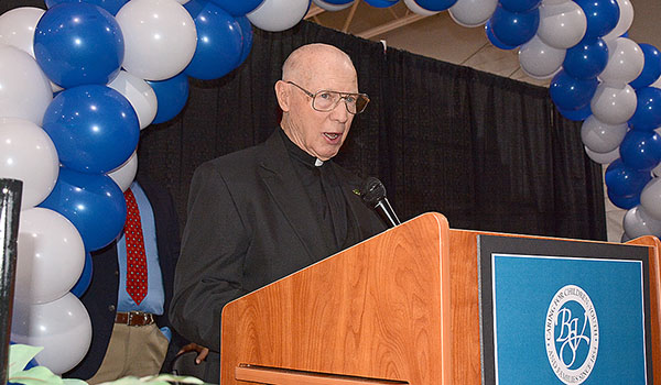 Msgr. Leo McCarthy speaks during the blessing and dedication of the gymnasium named after him. A lifelong youth coach and advocate for `Father Baker's,` Msgr. McCarthy chaired the fundraising drive and renovations of Baker Hall School's gymnasium. (Dan Cappellazzo/Staff Photographer)