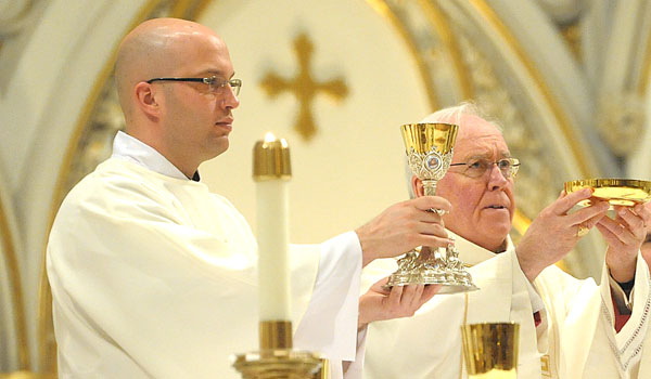 Transitional Deacon Michael LaMarca (left) has been serving at St. Joseph Cathedral this year. He will be ordained by Bishop Richard J. Malone (right) this Saturday. (Patrick McPartland/Staff Photographer)