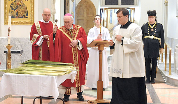 Bishop Richard J. Malone blesses palms before the start of Palm Sunday services at St. Joseph Cathedral.
(Patrick McPartland/Staff Photographer)