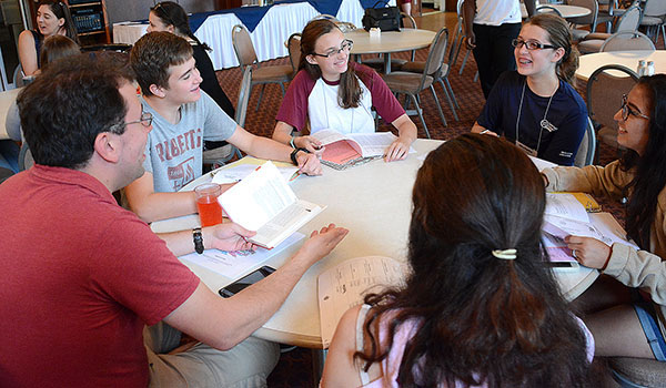 Michael Slish (left), program director of the Department of Youth & Young Adult Ministry, leads a discussion on personal skills during the Play to Your Strengths workshop at Christ the King Seminary. (Dan Cappellazzo/Staff Photographer)