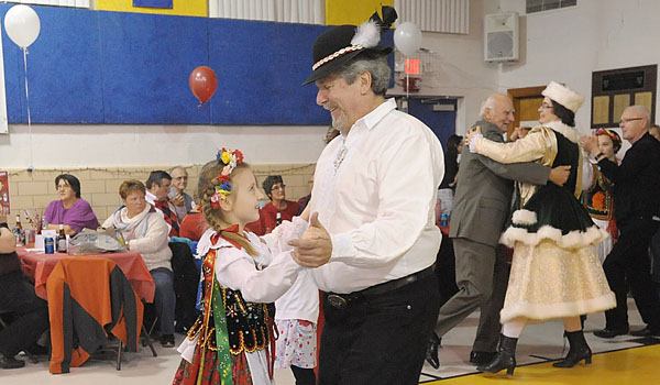 Douglas King and Victoria Pikula dance during Polish Night at St. John Church, Alden. The event was held to benefit St. John's Pilgrims for Poland World Youth Day in Krakow. Pikula is a member of the Polish Heritage Dancers of Western New York.
(Patrick McPartland/Staff Photographer)