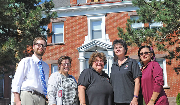 The staff of the Mother Teresa House, Emerson Stevens (left to right), Sarah Molitor, Director Cheryl Calire, Cheryl Zielen-Ersing and Miriam Escalante, welcomed their first residents in September. (Dan Cappellazzo/Staff Photographer)