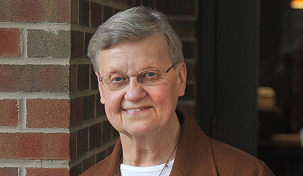 Sister Lorianne Tylczynski, CSSF, holds a photo of her order from around the 1950s. (Dan Cappellazzo/Staff Photographer)