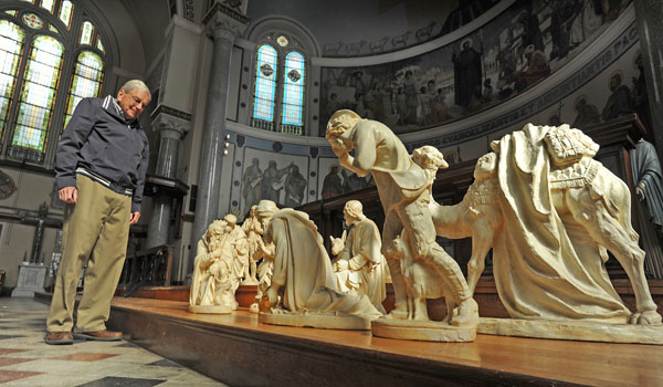 Bill Koch, vice president of the Buffalo Religious Arts Museum, looks over a Nativity scene at the museum donated by a local parishioner. The museum, located at the former St. Francis Xavier Church in the Black Rock neighborhood of Buffalo, was created in 2008. (Dan Cappellazzo/Staff Photographer)