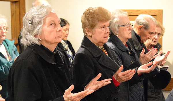 The faithful pray the Our Father during the Roe v. Wade observance Mass at St. Christopher Parish in Tonawanda. (Patrick McPartland/Staff Photographer)