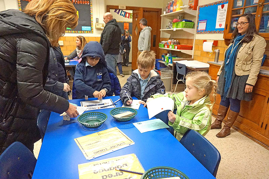 At the STREAM Reveal Night in November the Fleckenstein family work together on a STREAM engineering challenge in the St. John's Makerspace.  (Courtesy of St. John the Baptist)