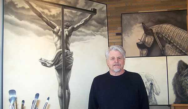 Artist Henry Schmidt shows off his `Christ, a Point of View.` The charcoal and oil on canvas has garnered the interest of Buffalo States College's Campus Ministry. (Patrick McPartland/Staff Photographer)