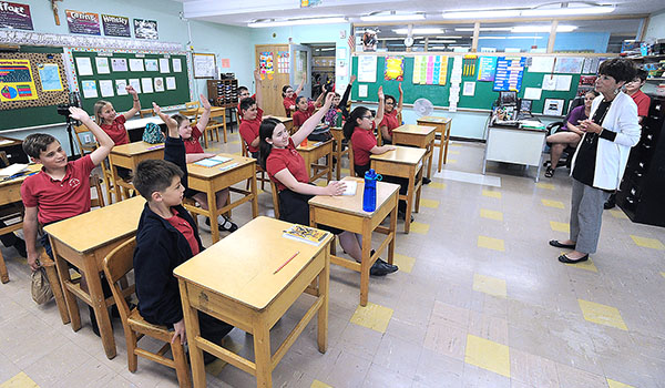 Maureen Ingham, principal of St. Peter School in Lewiston, speaks to students about the importance of faith. (Dan Cappellazzo/Staff Photographer)