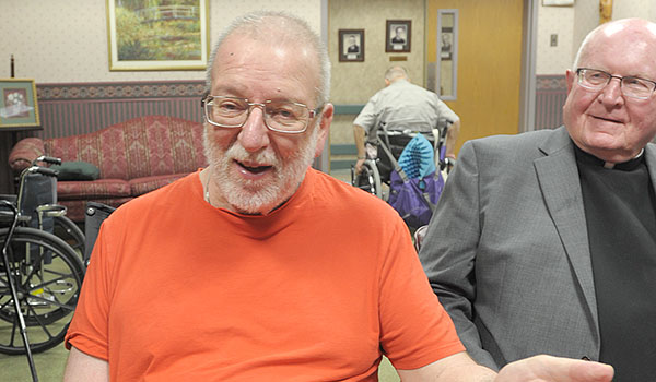 Father Guy Siracuse eats lunch with seminary classmates, including Father William Bigelow, at Brothers of Mercy Nursing Home and Rehabilitation Center in Clarence. Father Siracuse has lived at Brothers of Mercy since having a stroke in 1999. (Dan Cappellazzo/Staff Photographer)