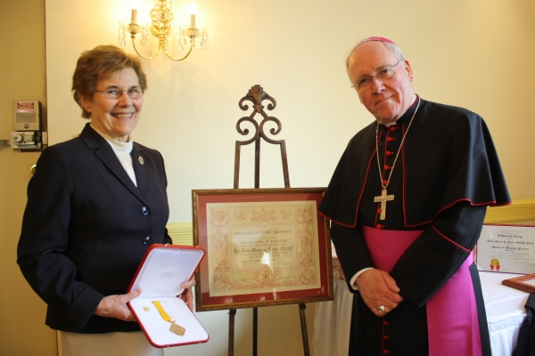 Sr. Denise A. Roche accepts Papal award from Bishop Richard J. Malone 