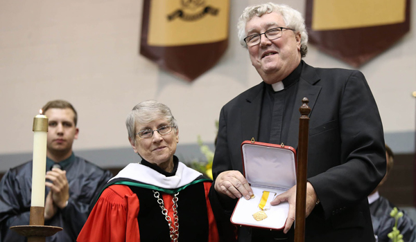 Sister Margaret Carney, OSF, was recognized by Father Gregory Dobson during Mass Saturday. (Courtesy of SBU)