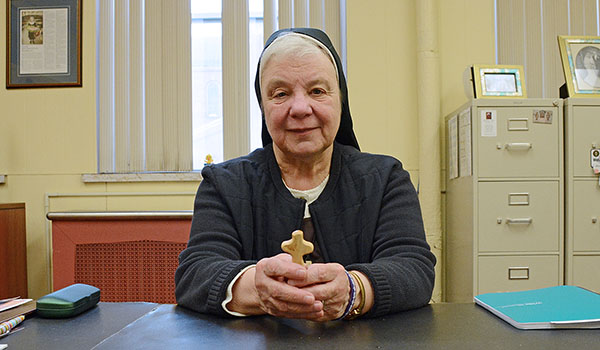 Sister Johnice Rzadkiewicz, CSSF, holds the small wooden cross like the one she gave her brother, Jack, while he was ill. (Patrick McPartland/Staff Photographer)